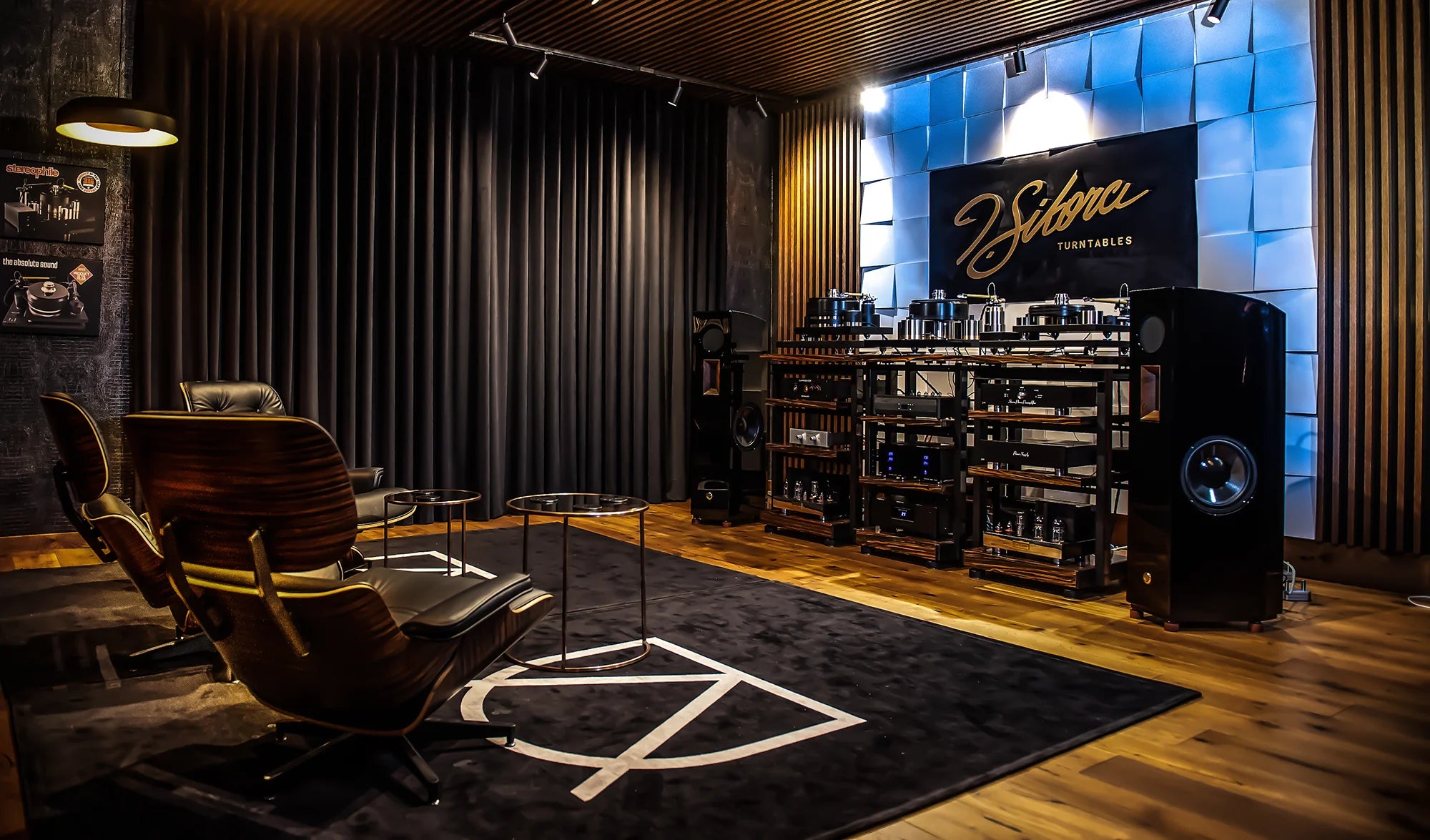 Modern interior with dark curtains, wooden floor, a shelf with decorative items, and J. Sikora Turntables with hi-end audio system.