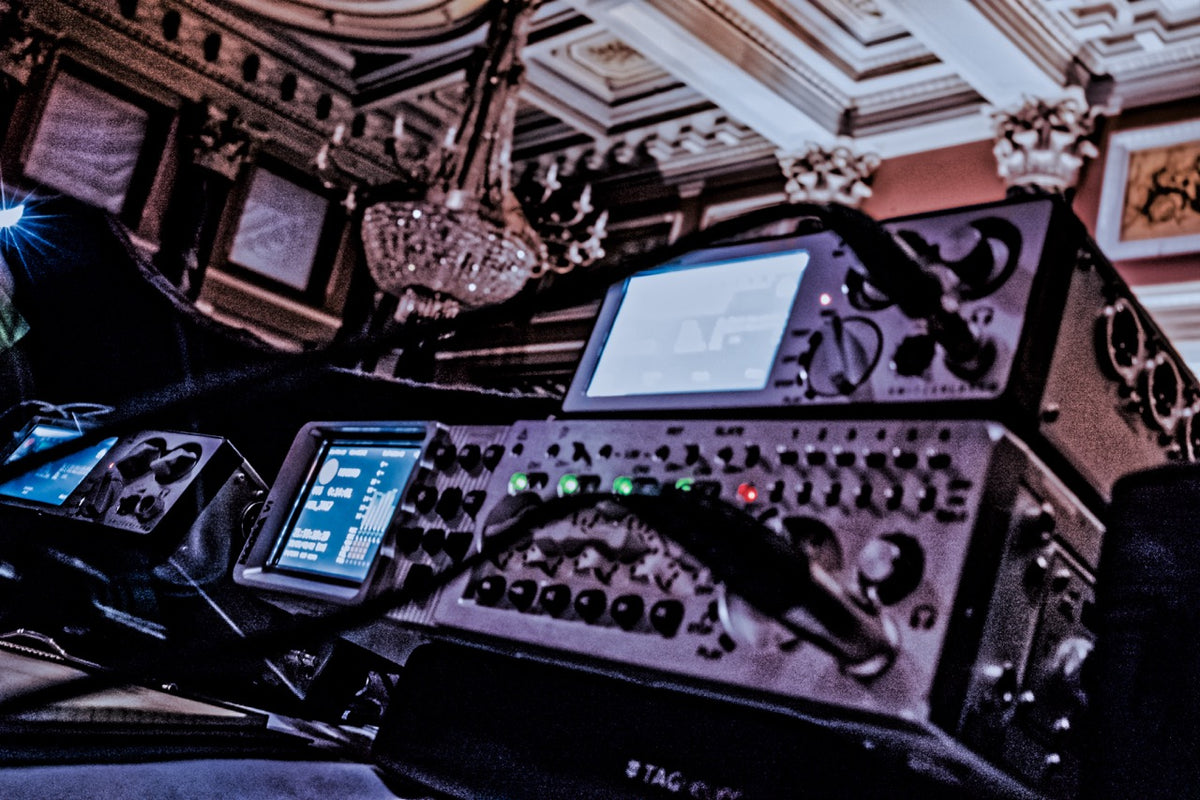 Nagra recorder in a dimly lit room with decorative ceiling.